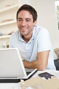 Young man working with laptop computer