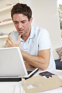 Young man working with laptop computer