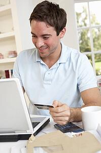 Young man using credit card on the internet