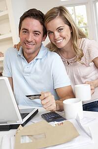 Young couple using credit card on the internet