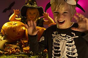 Halloween party with children wearing scaring costumes