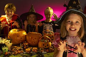 Halloween party with children wearing scaring costumes
