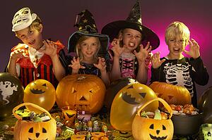 Halloween party with children wearing fancy costumes
