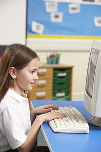 Schoolgirl In IT Class Using Computer