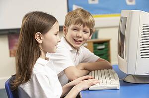 Schoolchildren In IT Class Using Computer