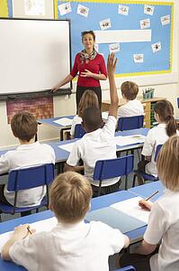 Schoolchildren Studying In Classroom With Teacher