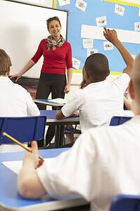 Schoolchildren Studying In Classroom With Teacher