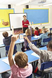 Schoolchildren Studying In Classroom With Teacher