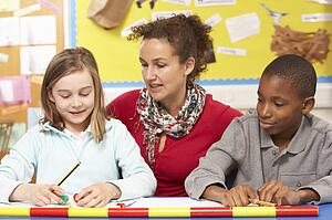 Schoolchildren Studying in classroom with teacher