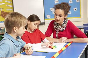 Schoolchildren Studying in classroom with teacher