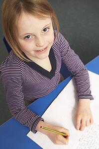 Schoolgirl Studying In Classroom