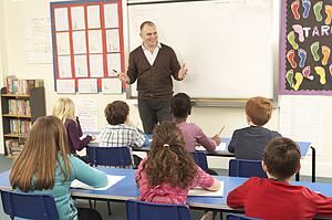 Schoolchildren Studying In Classroom With Teacher