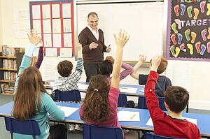 Schoolchildren Studying In Classroom With Teacher