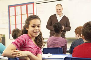Schoolchildren Studying In Classroom With Teacher