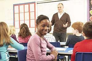 Schoolchildren Studying In Classroom With Teacher