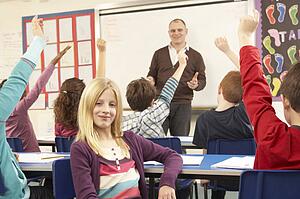 Schoolchildren Studying In Classroom With Teacher