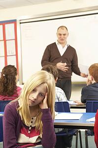 Schoolchildren Studying In Classroom With Teacher