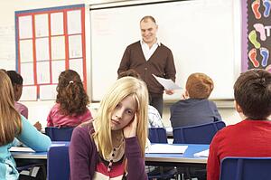 Schoolchildren Studying In Classroom With Teacher