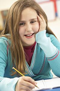 Schoolgirl Studying In Classroom