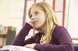 Schoolgirl Studying In Classroom