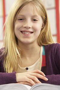 Schoolgirl Studying In Classroom