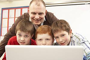 Group Of Schoolboys In IT Class Using Computer