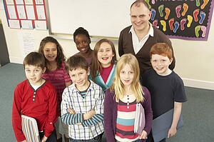 Portrait Of Schoolchildren Standing In Classroom