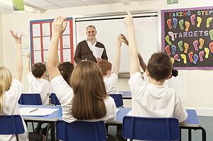 Schoolchildren Studying In Classroom With Teacher