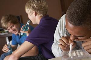 Group Of Teenage Boys Taking Drugs At Home
