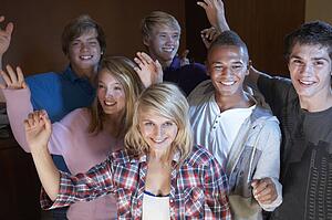 Group Of Teenage Friends Dancing And Drinking Alcohol