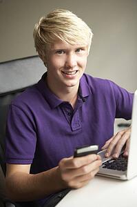 Teenage Boy Lying In Bedroom Drinking