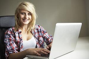 Teenage Girl Using Laptop At Home