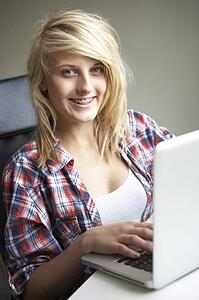 Teenage Girl Using Laptop At Home