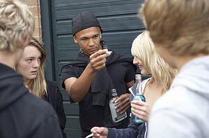 Group Of Threatening Teenagers Hanging Out Together Outside Drin