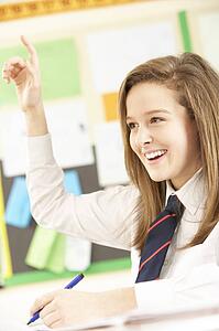Teenage Female Student Answering Question In Classroom