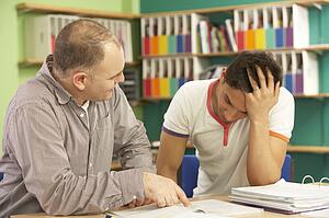 Teenage Student In Classroom With Tutor