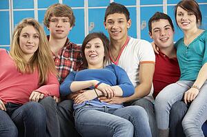 Teenage Students Relaxing By Lockers In School