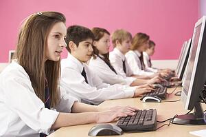 Teenage Students In IT Class Using Computers In Classroom