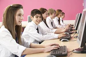 Teenage Students In IT Class Using Computers In Classroom