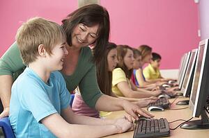 Teenage Students In IT Class Using Computers In Classroom With T