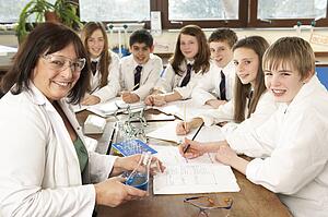 Group Of Teenage Students In Science Class With Tutor