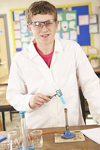 Male Teenage Student In Science Class With Experiment