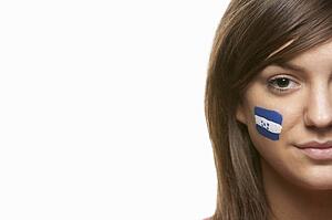 Young Female Sports Fan With Honduras Flag Painted On Face