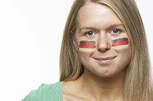 Young Female Sports Fan With German Flag Painted On Face