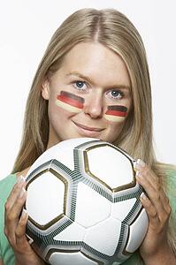 Young Female Sports Fan With German Flag Painted On Face