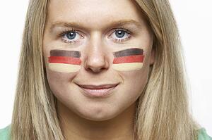 Young Female Sports Fan With German Flag Painted On Face
