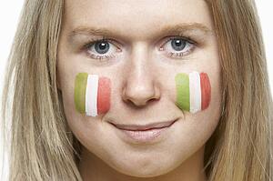 Young Female Sports Fan With Italian Flag Painted On Face