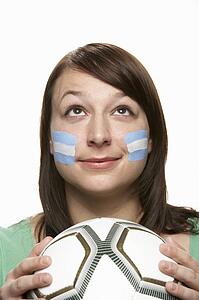 Young Female Football Fan With Argentinian Flag Painted On Face