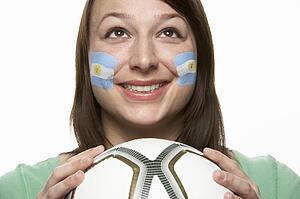 Young Female Football Fan With Argentinian Flag Painted On Face