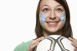 Young Female Football Fan With Argentinian Flag Painted On Face